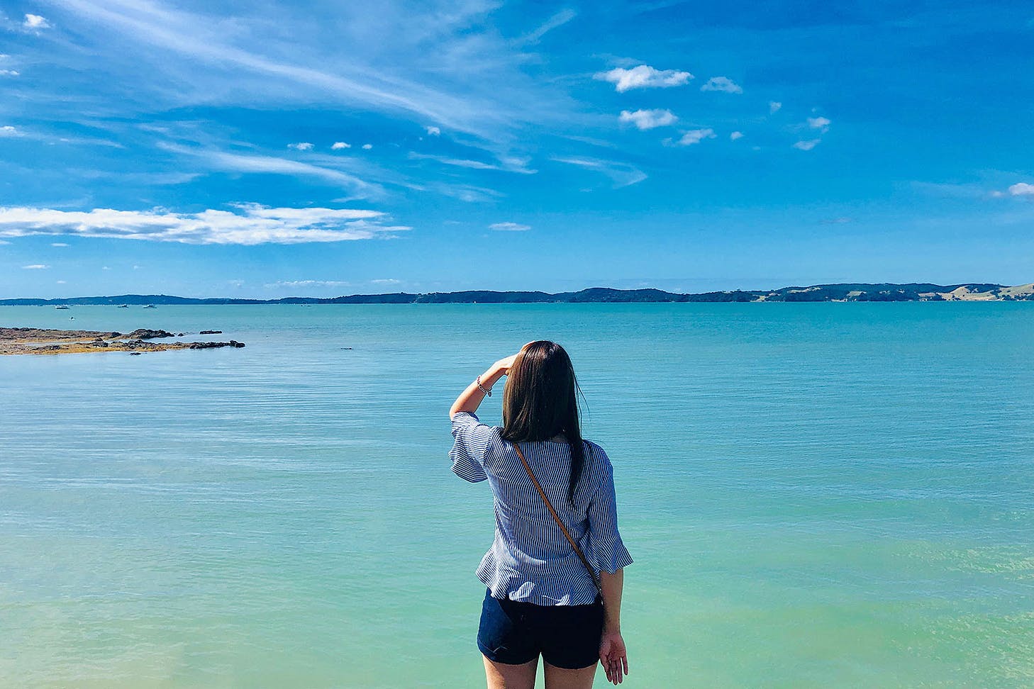 Rear View Of Woman Looking At Sea Against Sky in Maraetai.